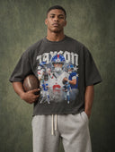 Monaco Social Club Football Club: model in a washed black oversized boxy raw hem tee with a vintage football player collage front graphic, holding a leather football
