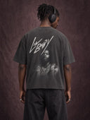 Monaco Social Club Music Club: model seen from behind wearing headphones and a washed black oversized boxy raw hem tee with a hip-hop artist portrait back graphic