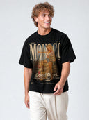 Black Monaco Backroads paneled tee worn by model, angled front view with cowgirl and roadside sign graphic.
