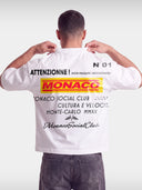 Monaco Trackside white boxy tee worn by model, back view with red and yellow MONACO racing print.