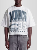 Model wearing the 35 Authentic Club Heavyweight Boxy Tee in White with collegiate Monaco Athletic Dept. graphic — Monaco Social Club streetwear