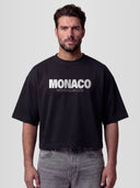 Man model wearing the 35 Jersey Heavyweight Boxy Tee in Black with Monaco Social Club star badge and halftone #35 back graphic — Monaco Social Club streetwear