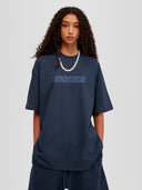 Woman model wearing the Tonal Heavyweight Tee in Midnight Navy with tone-on-tone Monaco Social Club chest print — Monaco Social Club streetwear