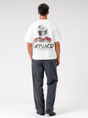 Grid Reaper Arctic White oversized paneled tee worn by model, back view with skull racing driver graphic.