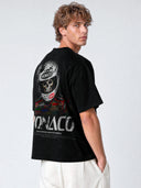 Black Grid Reaper oversized paneled tee worn by model, three-quarter back view of racing graphic.