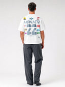 Arctic white Paddock paneled tee worn by model, back view with distressed gray Monaco 22 racing graphic and badges.