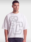 Monaco Club white boxy tee worn by model, front view with tonal grey SC monogram and star.