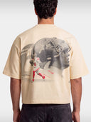 Ivory No. 6 Next Chapter boxy tee worn by model, back view with football player photo print.