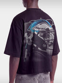 Monaco No. 1 Flight boxy tee in black, worn by model, angled view with teal winged helmet and quarterback graphic.