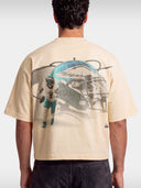 Ivory No. 1 Flight boxy tee worn by model, back view with faded helmet and quarterback graphic.
