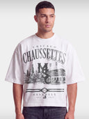 Monaco Chaussettes white boxy tee worn by model, front view with Chicago skyline baseball print.