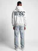 Rear model view of heather gray Monaco MSC hoodie with charcoal logo graphic and structured typographic text.