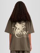Model wearing taupe Monaco Social Club oversized tee with beige eagle back graphic