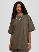 Model wearing taupe Monaco Social Club oversized tee with dropped shoulders
