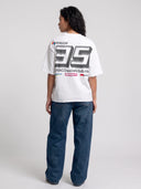 Arctic white Monaco Sponsor oversized tee worn by model, back view with bold No. 35 and sponsor-style logos.
