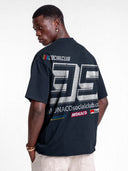 Navy blue Monaco Sponsor raw hem tee worn by model, back view with oversized white No. 35 and sponsor logos.