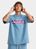 Slate blue Monaco Sponsor oversized racing tee on model, front view with Monaco logo and No. 35 graphic.