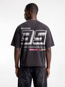 Dark grey Monaco Sponsor oversized tee worn by model, back view with bold No. 35 and sponsor-style logos.
