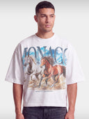 Monaco Run Wild white boxy tee worn by model, front view with galloping horses graphic.