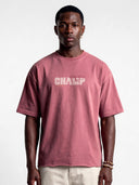 Model in faded merlot Monaco Champ heavyweight tee, front view highlighting the cream chest logo and raw hem.