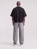 Monaco black boxy tee worn by model, full-length back view showing boxy fit and drop shoulders.