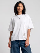 Arctic white Untamed raw hem T-shirt worn by model, front view showing the vertical Monaco motto graphic.