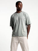 Model wearing the light grey Untamed oversized tee, front view with Monaco signature and motto graphic.