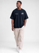 Navy blue Open Land oversized tee worn by model, front view with Monaco wordmark and horse chest print.