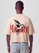 Man model wearing the Pegasus Heavyweight Boxy Tee in Cream with winged horse and red Monaco serif wordmark graphic — Monaco Social Club streetwear