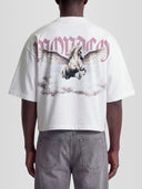 Man model wearing the Olympus Heavyweight Boxy Tee in White with Pegasus rising through clouds under gothic Monaco lettering — Monaco Social Club streetwear