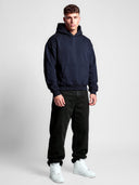 Navy Monaco Aesthetic tapered hoodie worn by model, front view with clean chest, kangaroo pocket and ribbed hem.
