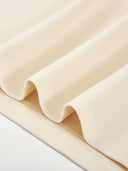 Close-up of Monaco ivory boxy tee showing 280 GSM cotton fabric and stitched hem.