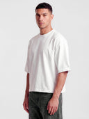 Monaco white boxy tee worn by model, angled front view with no chest graphic.