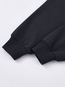 Black Monaco athleisure hoodie sleeve detail showing long sleeves with wide ribbed cuffs.