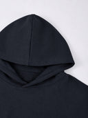 Black Monaco athleisure hoodie close-up showing structured hood construction and smooth fabric.