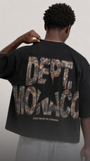 Model wearing the CAMO DEPT TEE from the back, featuring an oversized Realtree-inspired camo graphic on a black boxy T-shirt.