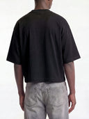 Black Monaco boxy tee on model, back view showing drop-shoulder sleeves and cropped hem.