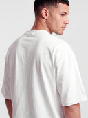 Close-up back view of Monaco white boxy tee on model, showing shoulder seam and cotton fabric.