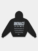 Black graphic hoodie back mockup by Monaco with light gray typography, logo marks and ribbed waistband.