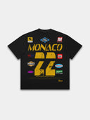 Black Paddock paneled shirt back mockup with distressed yellow Monaco 22 racing graphic and colorful badges.