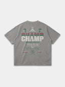 The Champ Tee in light grey, back mockup with cream, red and green typography and Monaco crest graphics.