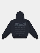 Navy Monaco streetwear hoodie back mockup featuring tonal dark branding, lifestyle statement and ribbed hem.