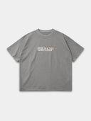 Light grey Monaco Champ oversized tee, front mockup with cream block lettering, red script and green stars.