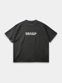 Dark grey Monaco Champ raw hem T-shirt, front mockup showing cream block lettering with red script accents.