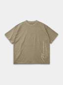 Khaki Untamed raw hem T-shirt, front mockup showing a vertical Monaco signature and motto text.