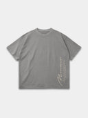 Light grey Untamed raw hem tee, front mockup with vertical Monaco signature graphic and stacked text.
