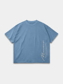 Slate blue Untamed heavyweight T-shirt, front mockup with vertical Monaco signature and motto graphic.