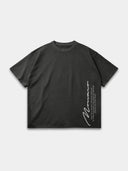 Dark grey Untamed oversized tee, front mockup showing the vertical Monaco signature and motto print.