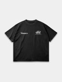 Faded black Open Land oversized tee worn by model, front view with Monaco and three-horse chest prints.