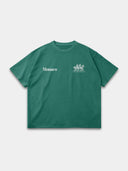 The Open Land Tee in vintage green, front mockup with white Monaco wordmark and three-horse chest graphic.